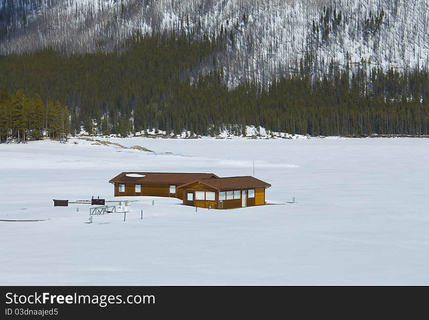 Majestic Sceneic of the frozen Lake Minnewanka, Banff National Park, Alberta, Canada. Fueling station gas pumps pertruding in the thick ice and snow. Majestic Sceneic of the frozen Lake Minnewanka, Banff National Park, Alberta, Canada. Fueling station gas pumps pertruding in the thick ice and snow.