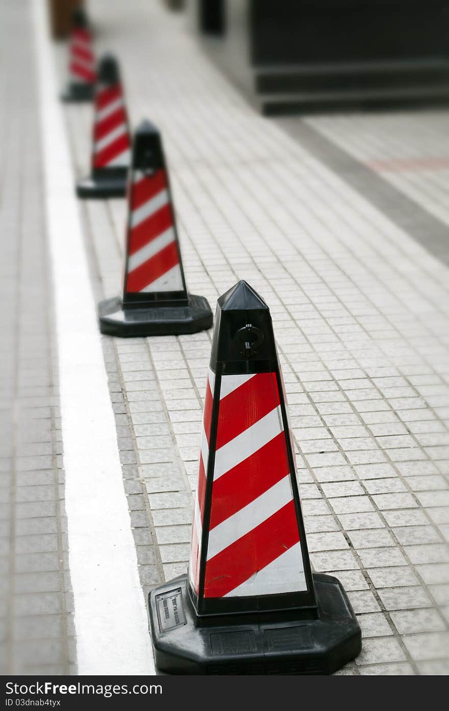 A road cone with reflective bands. A road cone with reflective bands