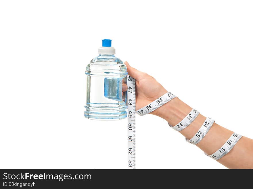 Diabetes diet concept tape measure twisted around woman hand, wrist and measuring blue bottle of drinking sparkling mineral water on a white background. Diabetes diet concept tape measure twisted around woman hand, wrist and measuring blue bottle of drinking sparkling mineral water on a white background