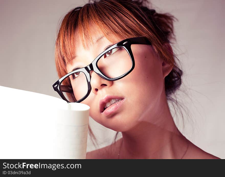 Asian girl holding a textbook. Wear a big black glasses. Asian girl holding a textbook. Wear a big black glasses.