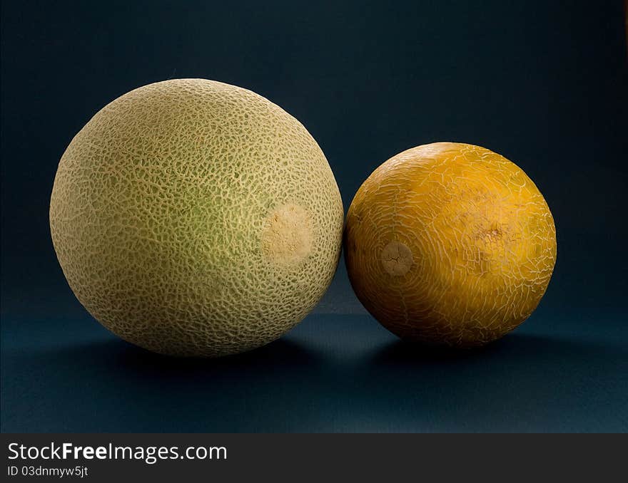 Two Cantaloupes - green and yellow. Two Cantaloupes - green and yellow