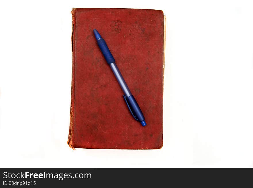 Old book and pen isolated on a white background