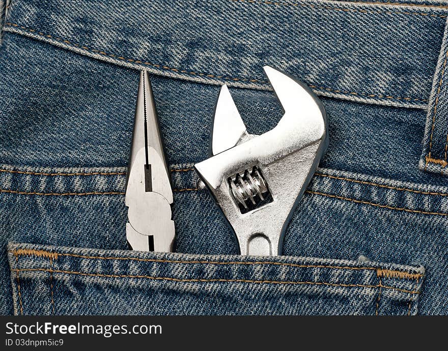 A clean blue jeans with wrench in the back pocket