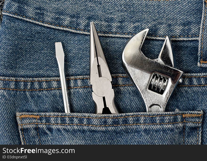 A clean blue jeans with wrench in the back pocket