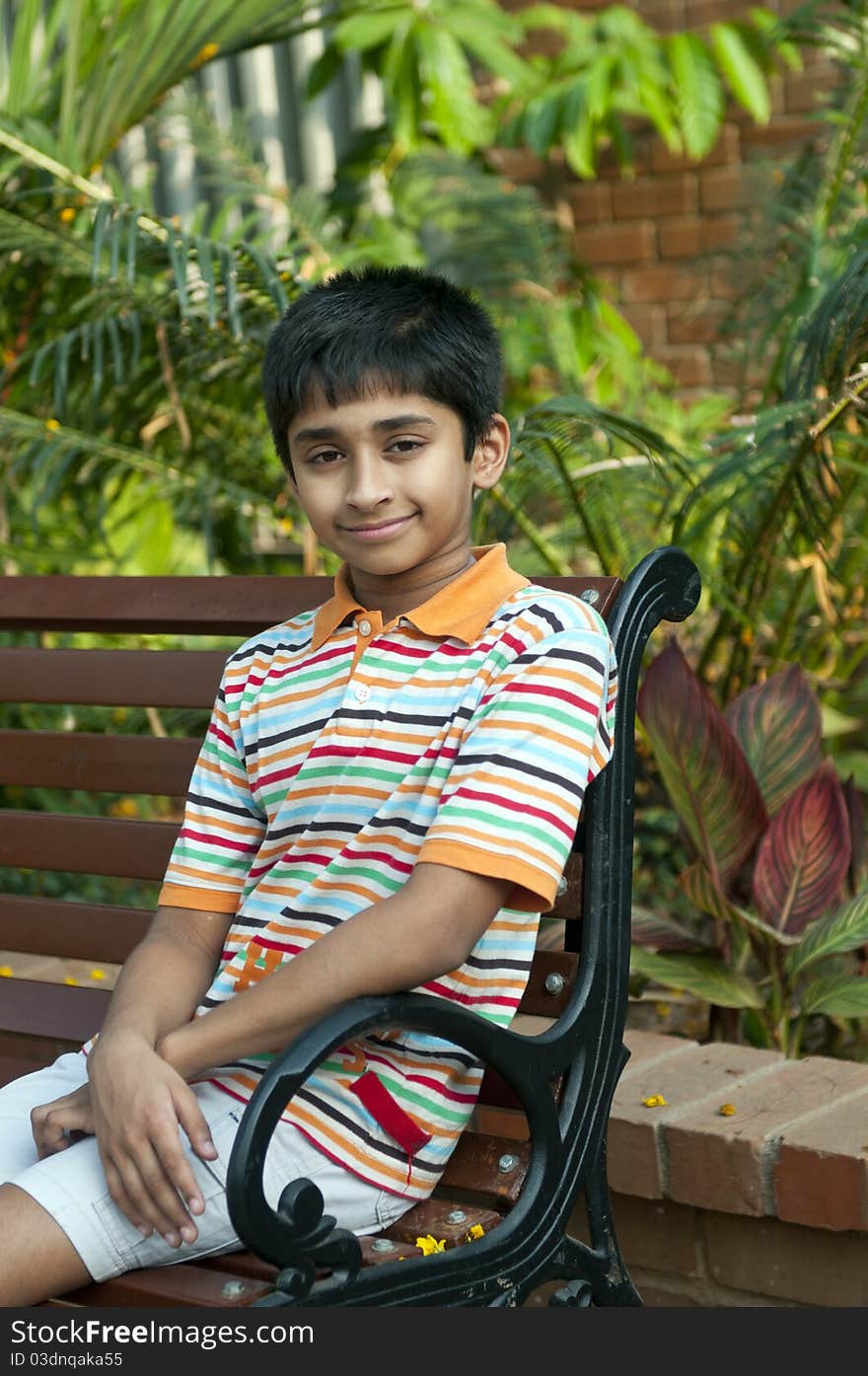 Two Indian brothers sitting happily at a local park