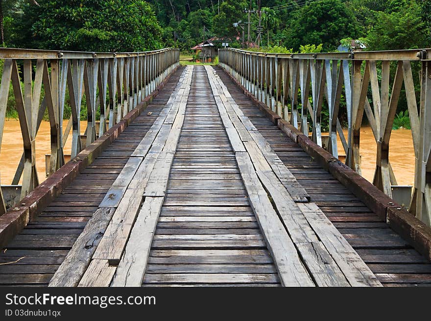 Old Bridge Over A Brown River