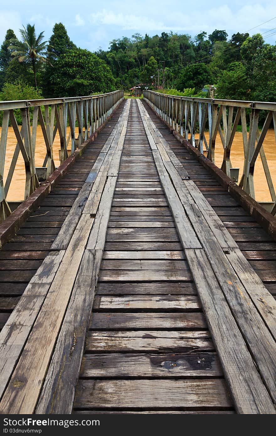 Old bridge over a brown river