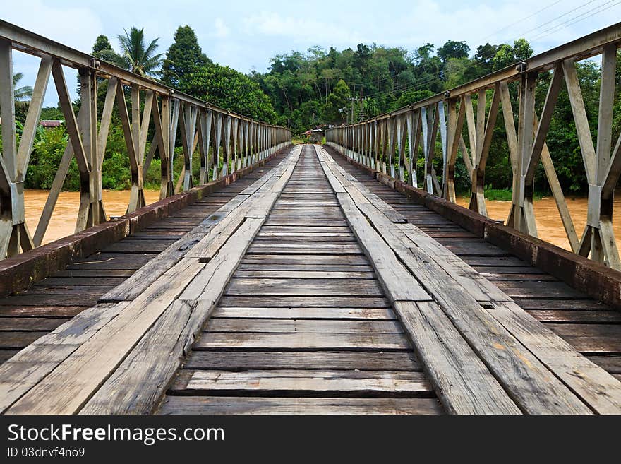 Old bridge over a brown river