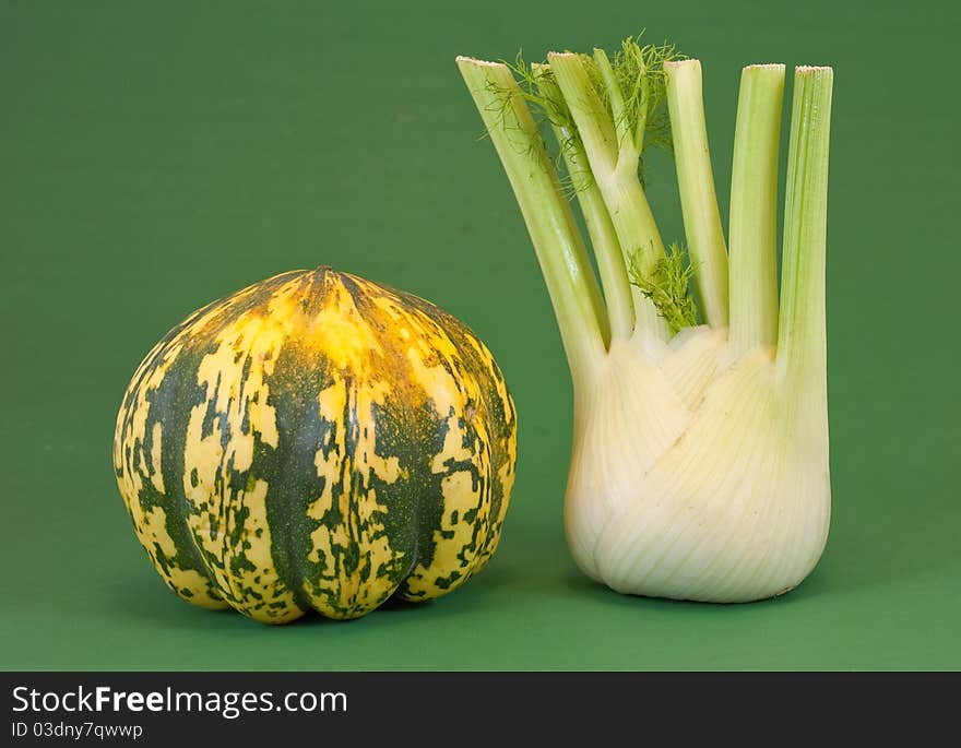 Fennel and pumpkin foreground on a green background