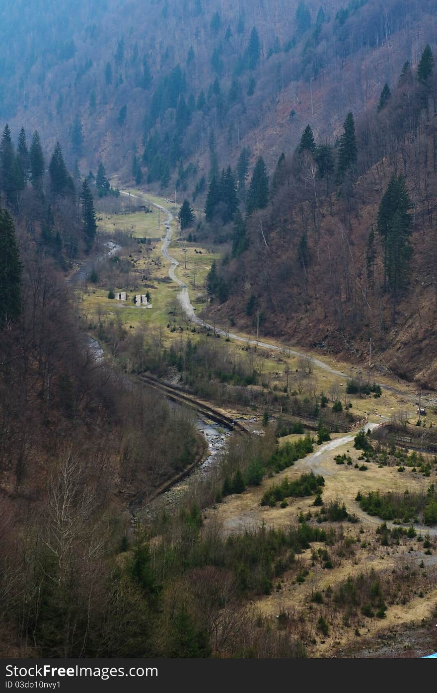 Small river flowing between hills and forests. Small river flowing between hills and forests