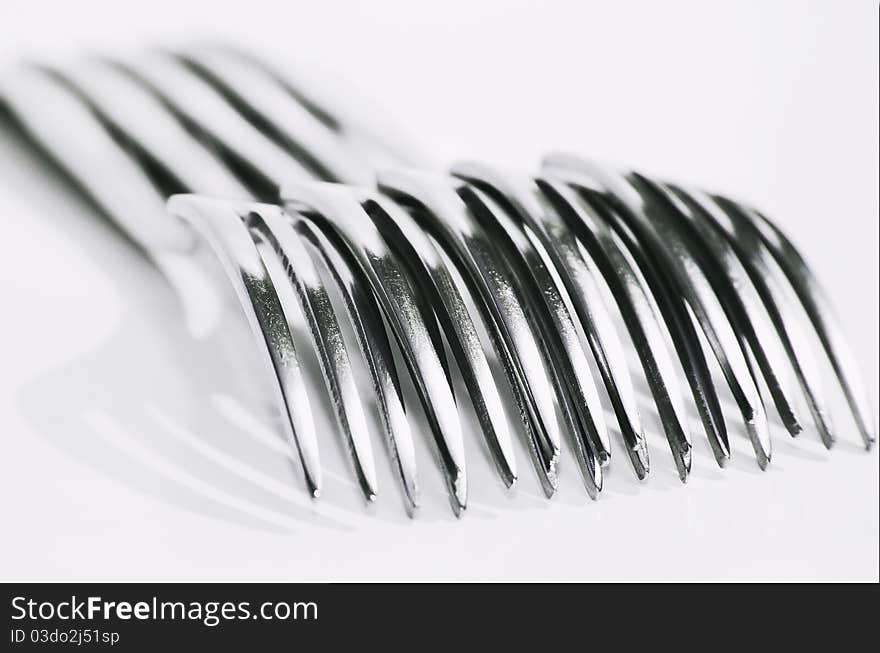 An image of stainless steel forks over a white background