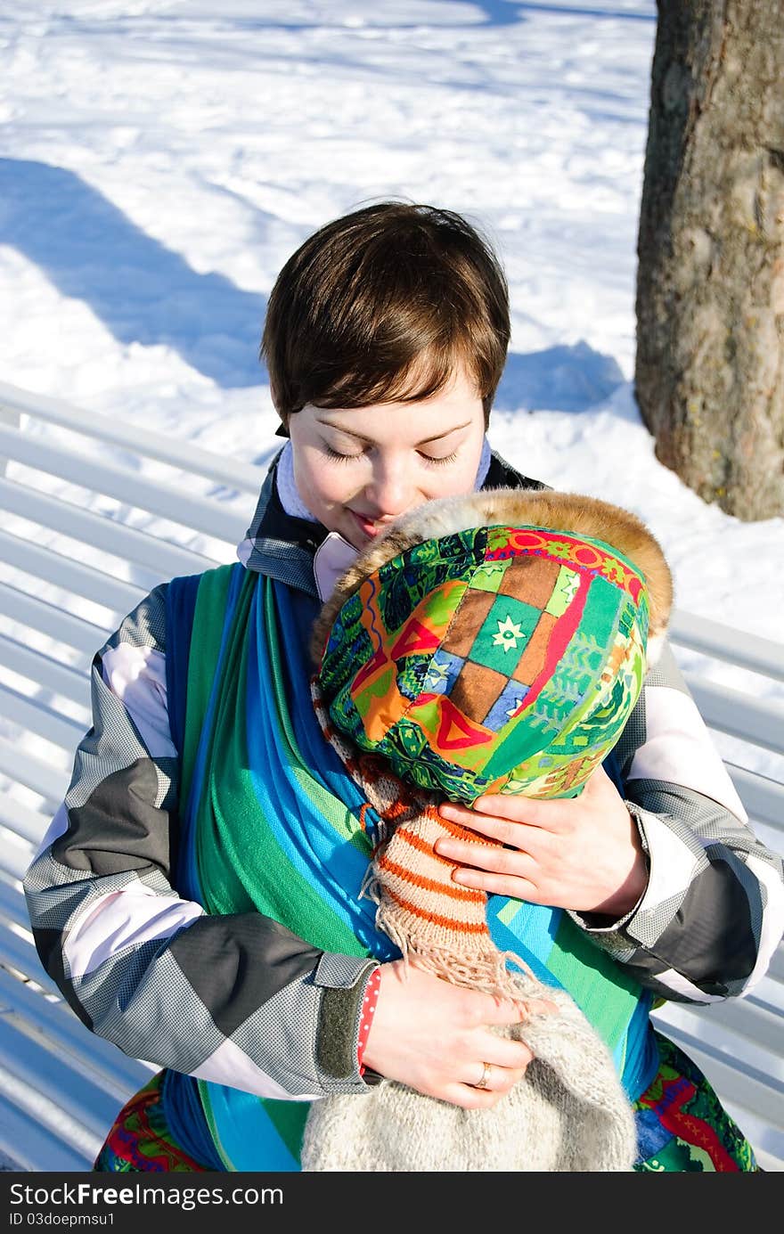 Young woman with her son in baby sling outdoor. Young woman with her son in baby sling outdoor