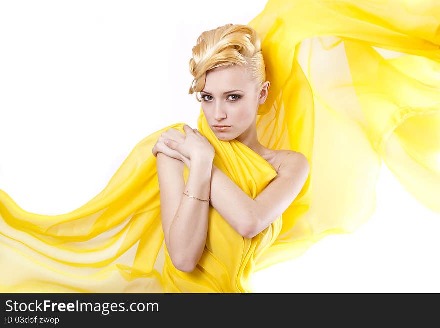 Beautiful Young girl blonde hair in a yellow cloth flying. Beautiful Young girl blonde hair in a yellow cloth flying