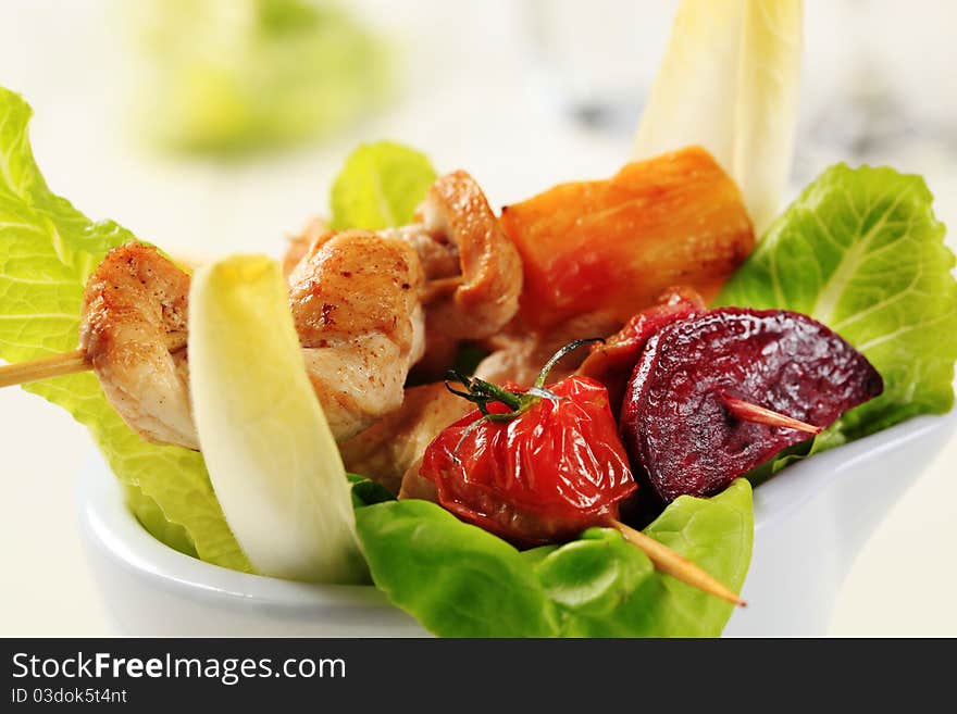 Chicken kebabs on leaves of fresh lettuce. Chicken kebabs on leaves of fresh lettuce