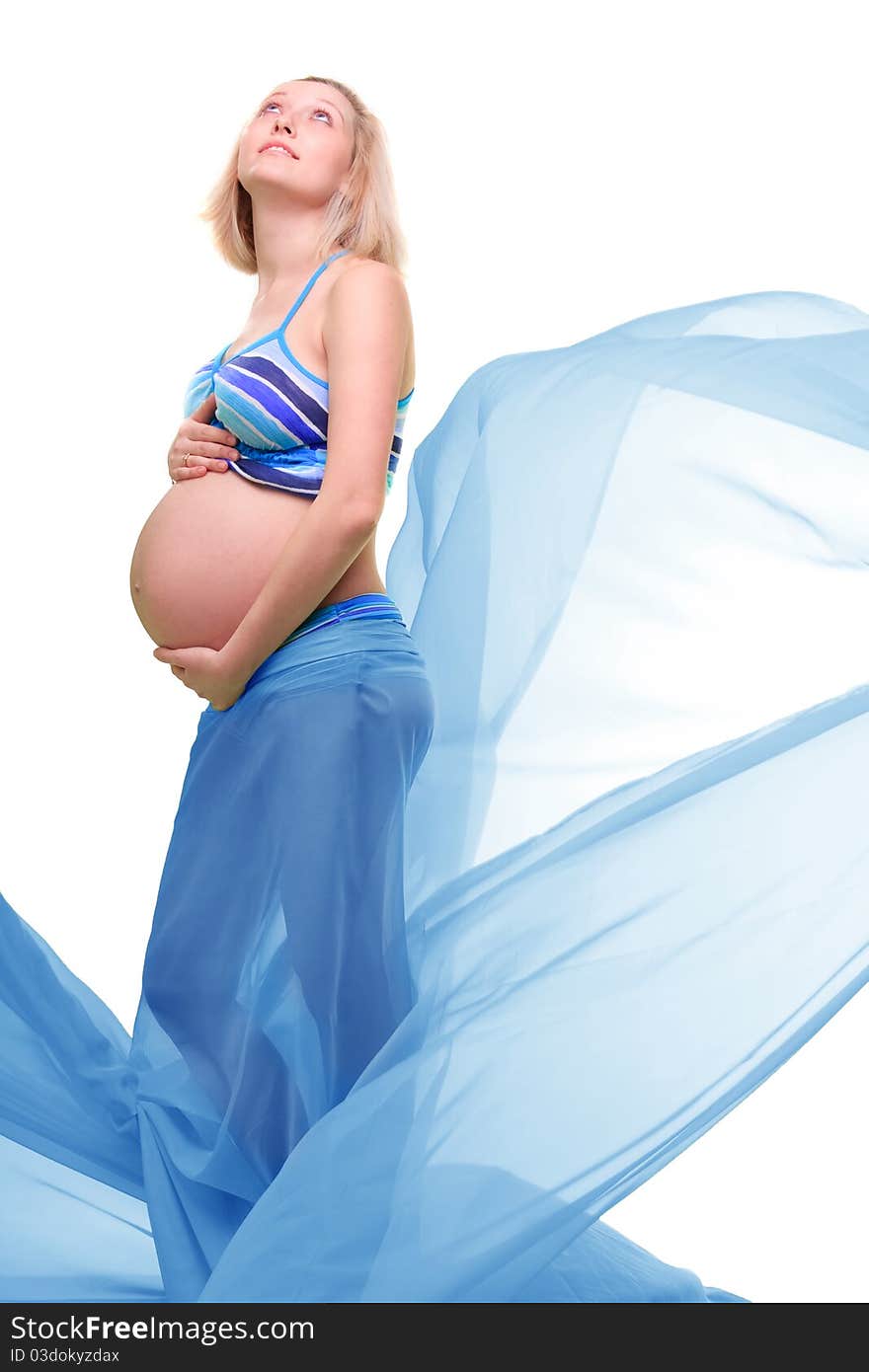 Beautiful young pregnant blonde woman with green transparent cloth in studio. Beautiful young pregnant blonde woman with green transparent cloth in studio