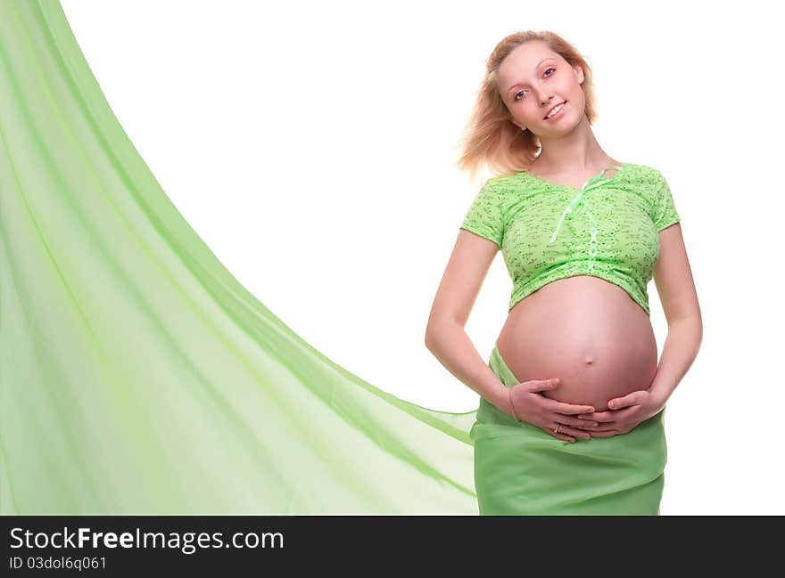 Beautiful young pregnant blonde woman with green transparent cloth in studio. Beautiful young pregnant blonde woman with green transparent cloth in studio