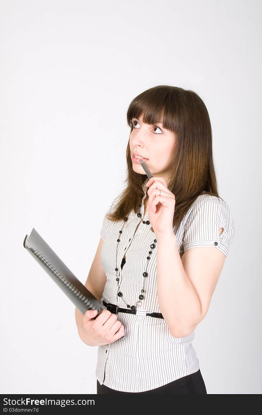 Business woman holding pen and clipboard with thinking expression isolated on white background. Business woman holding pen and clipboard with thinking expression isolated on white background