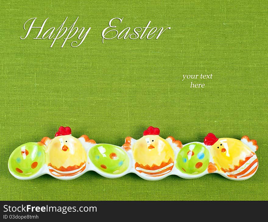 Easter composition: Colorful Easter eggs holder on a green flax background