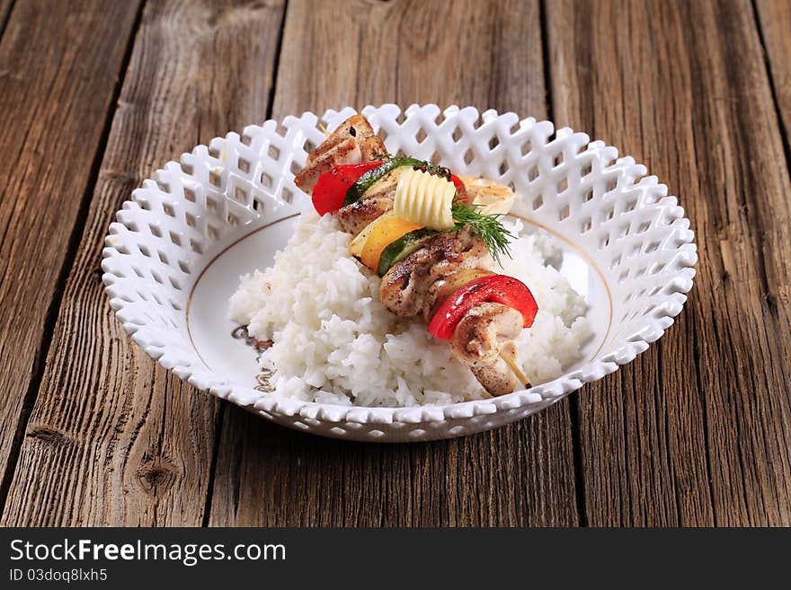 Chicken shish kebab on bed of white rice. Chicken shish kebab on bed of white rice