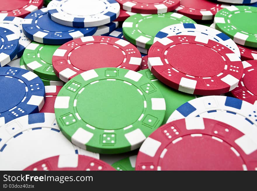 Many poker chips on the green table. Many poker chips on the green table