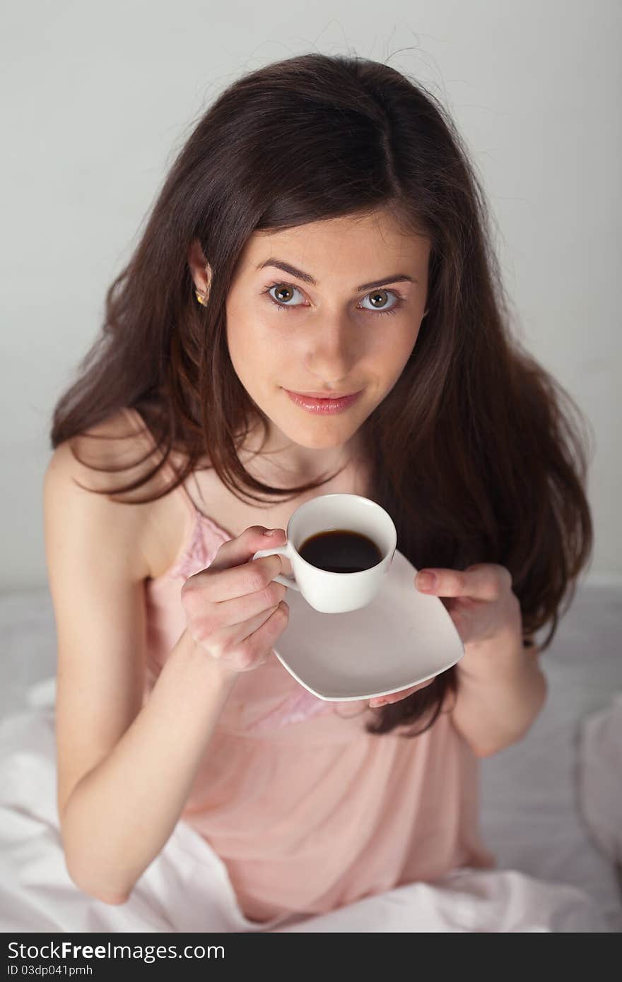 Girl With A Cup Of Coffee Looking Up