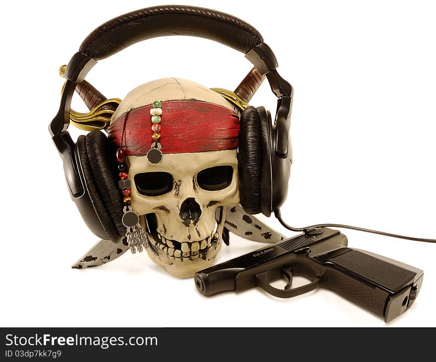 Skull in ear-phones with a lying pistol