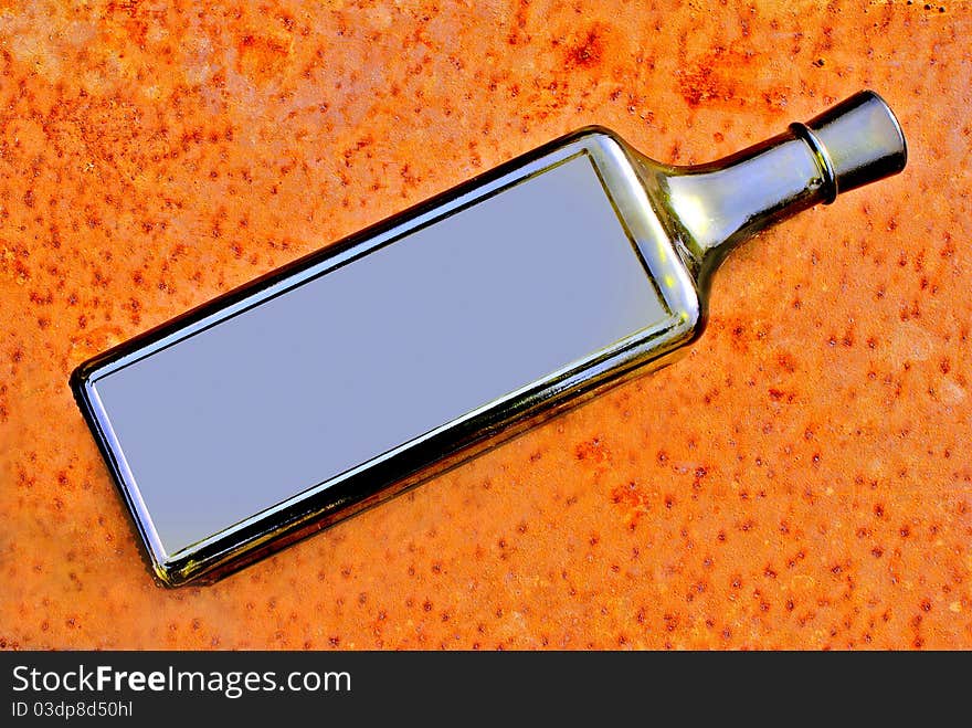 Glass bottle on sheet of a rusty tin. Glass bottle on sheet of a rusty tin.