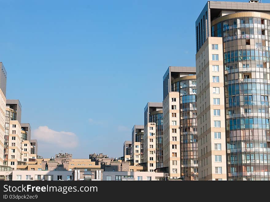 Dwelling houses constructed cascade on the blue sky background