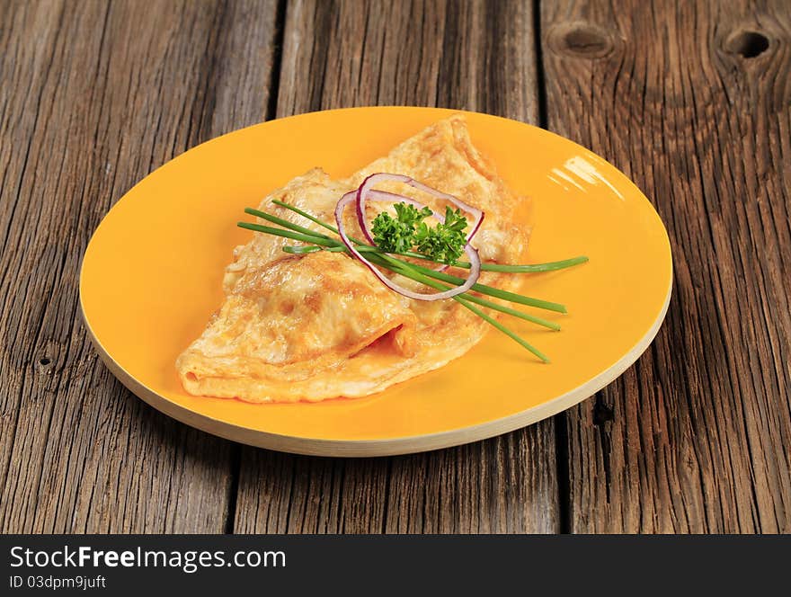 Egg omelet topped with fresh chives and onion