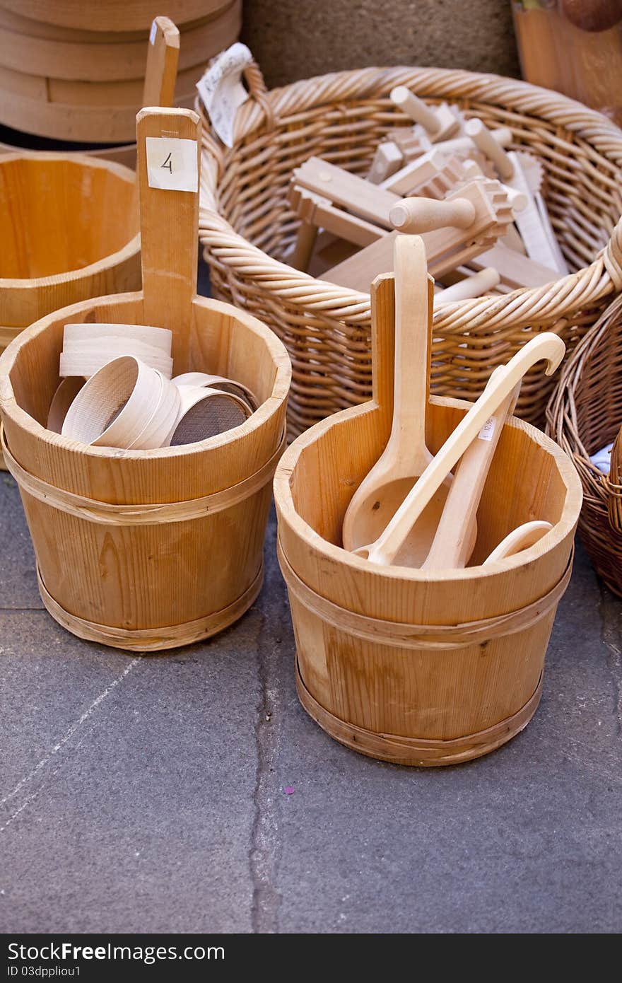 Wooden spoons inside a buckets in a street market