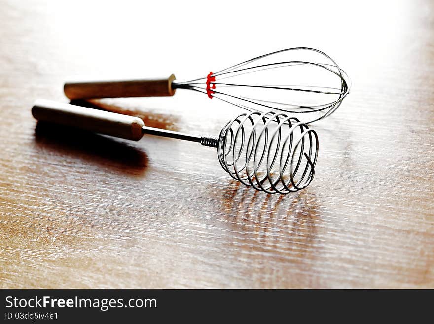 An image of two whisks on the kitchen table