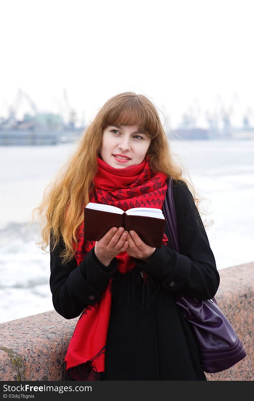 Young girl in the red scarf with notepad