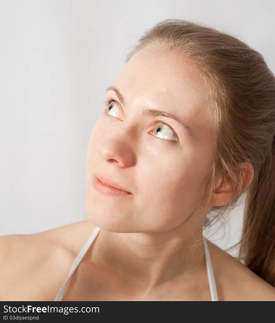 Portrait of blonde girl, looking up and left