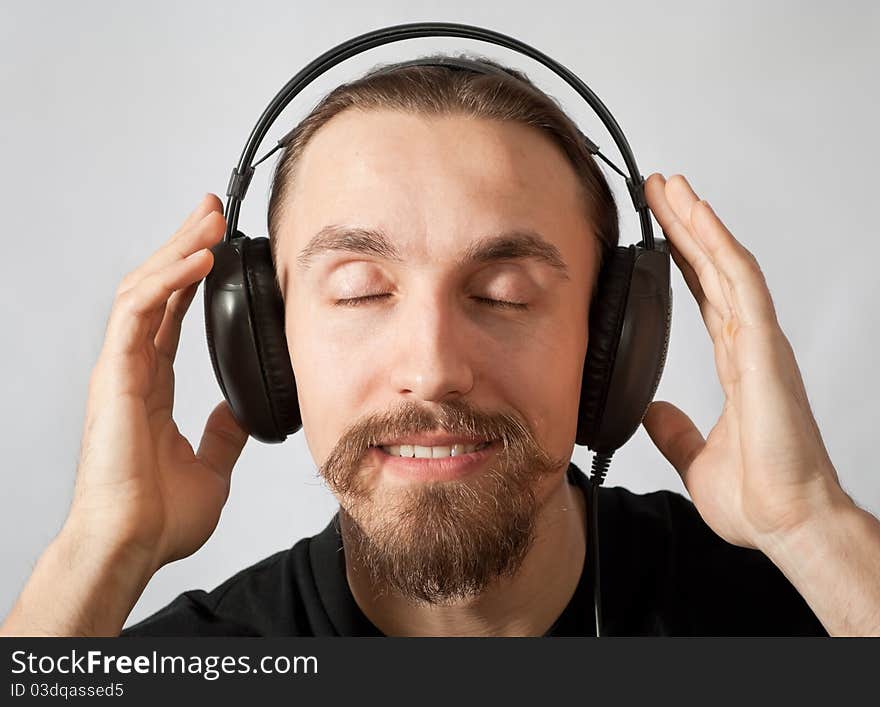 Young man in headphones with closed eyes