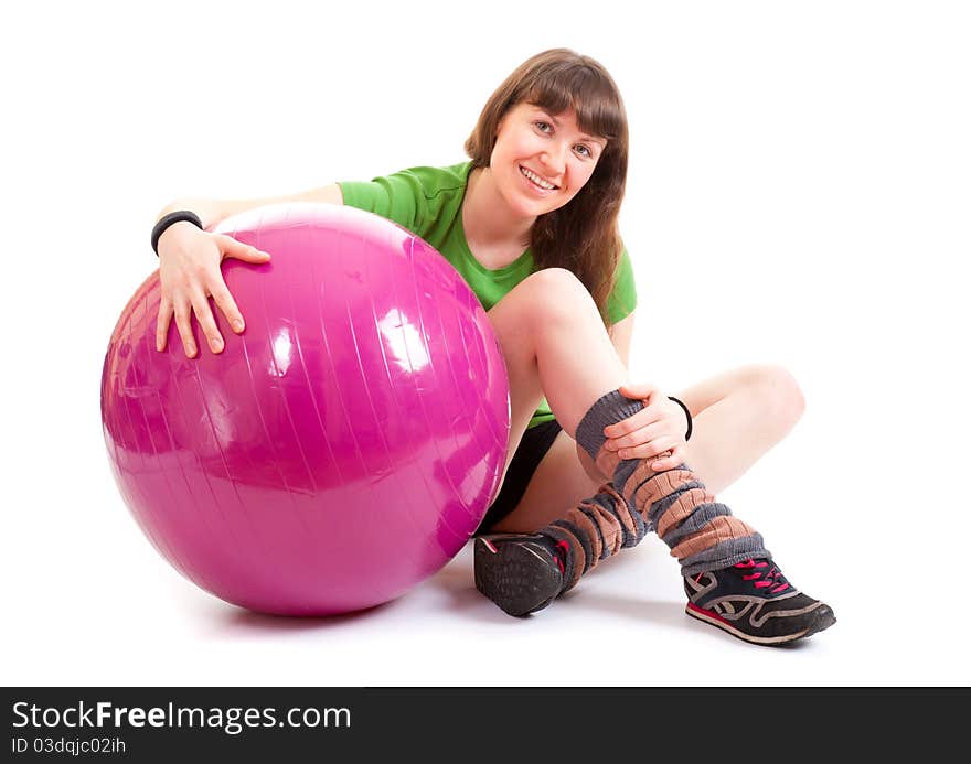 Young nice woman sitting with a big fitness ball. Young nice woman sitting with a big fitness ball