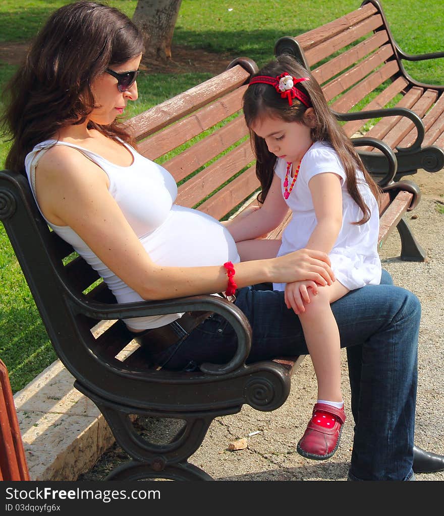 Pregnant mother talking to daughter