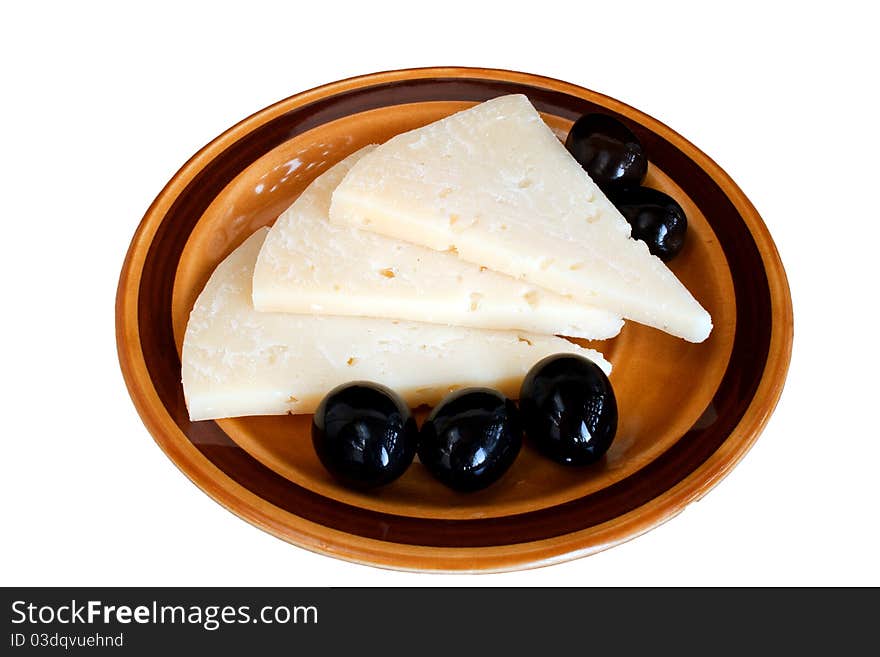 Slices of cheese and black olives on plate isolated over white