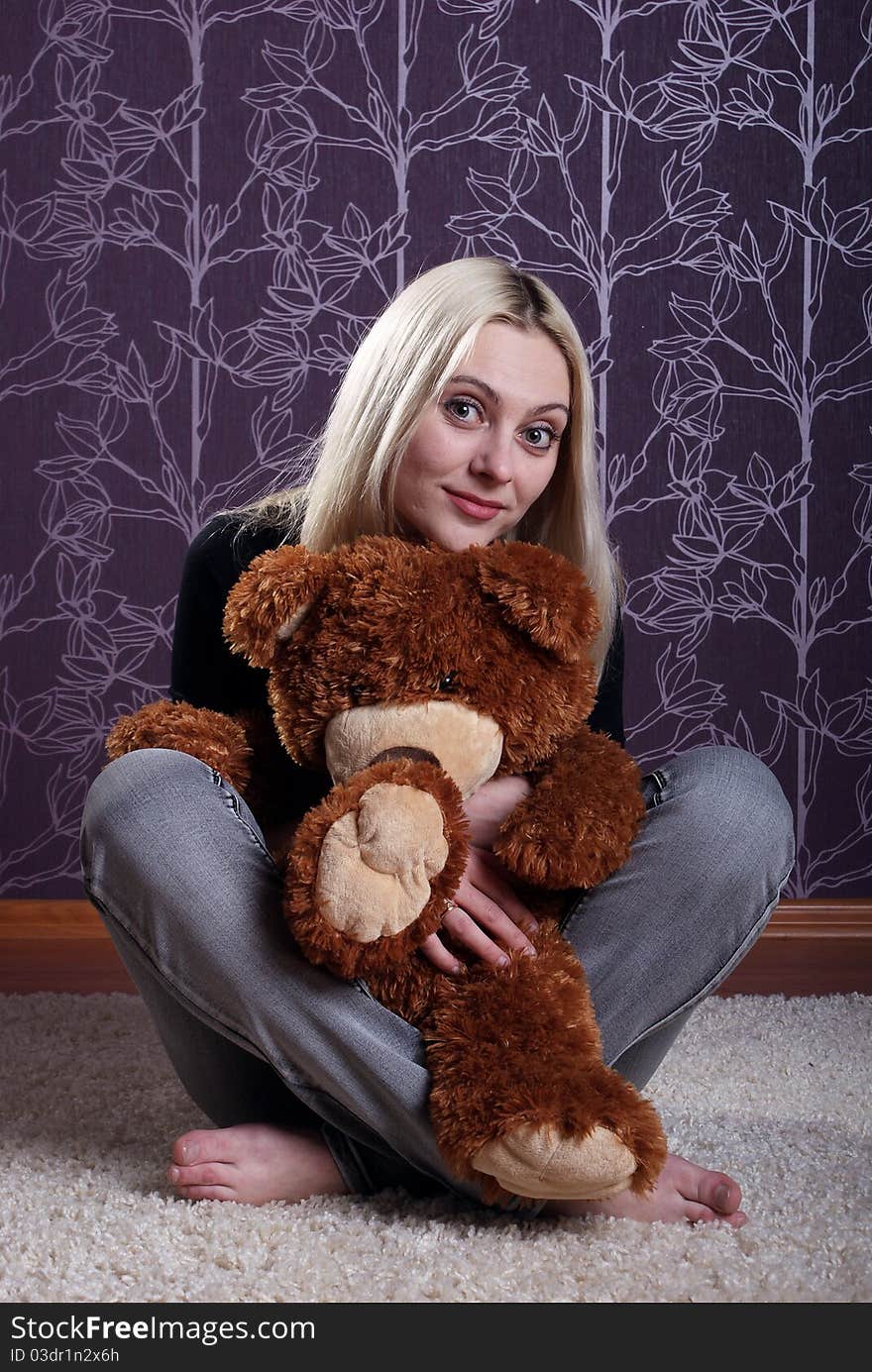 Girl embraces toy a bear. Girl embraces toy a bear