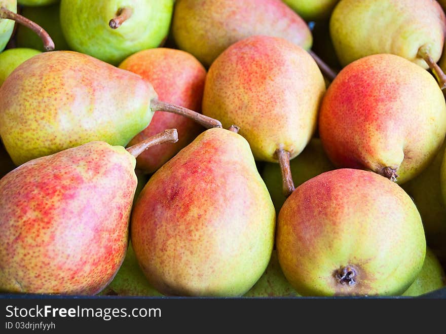 Freshly ripe pears in large boxes