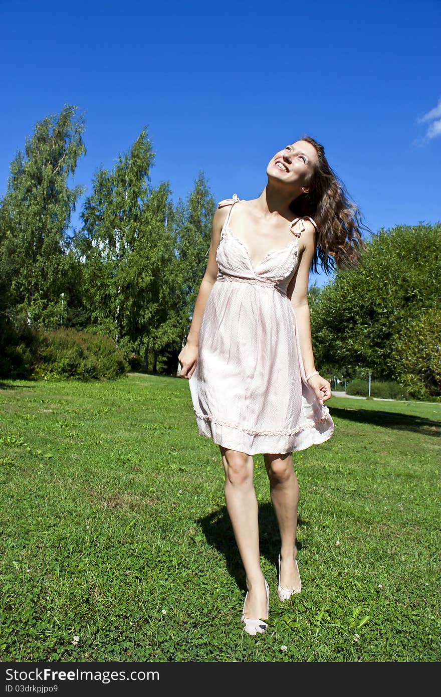 Beautiful Young Happy Woman Under Blue Sky.