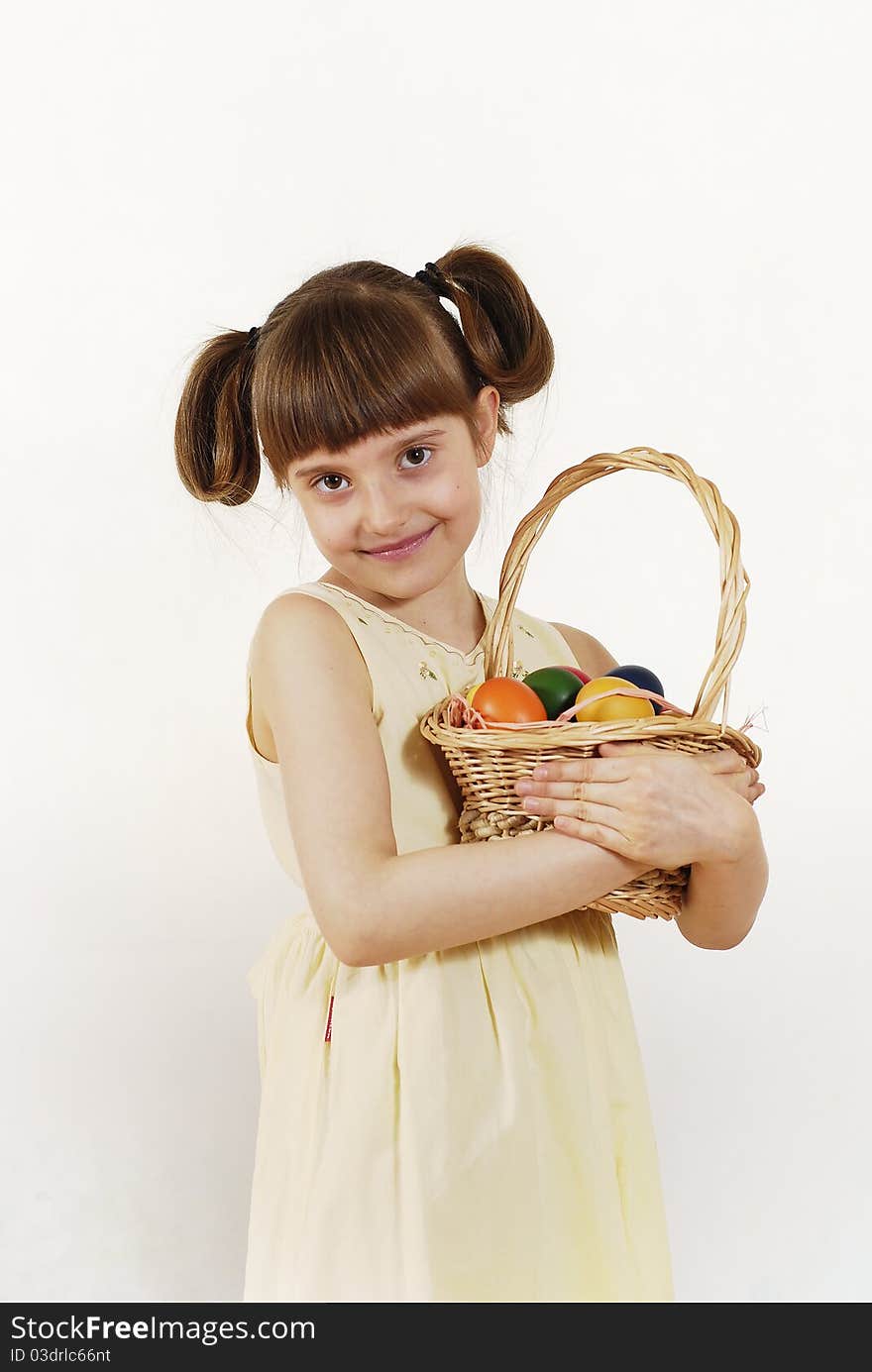 Girl keeping the basket with Easter painted eggs. Girl keeping the basket with Easter painted eggs