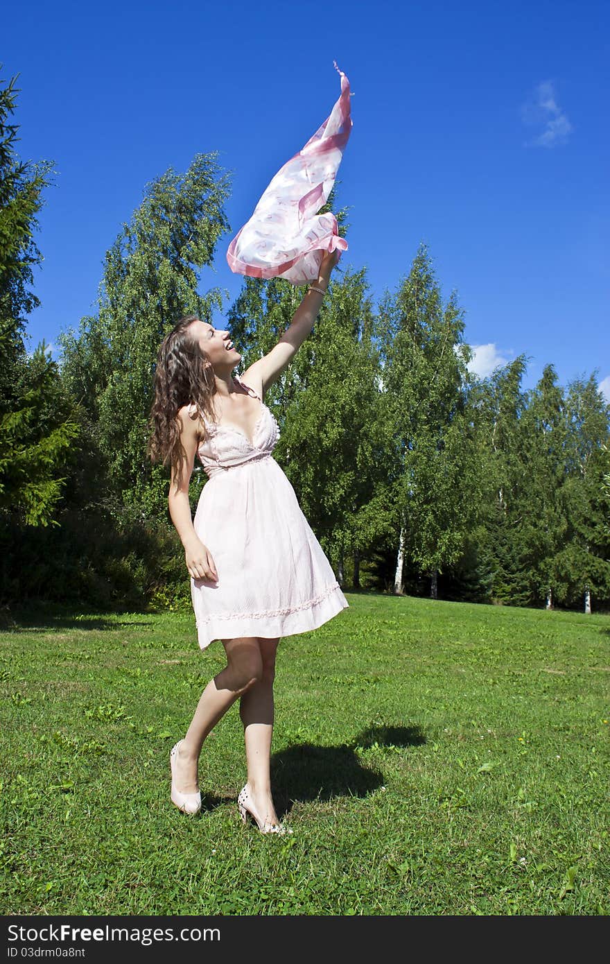 Beautiful young happy smiling girl with a scarf in hands. Beautiful young happy smiling girl with a scarf in hands