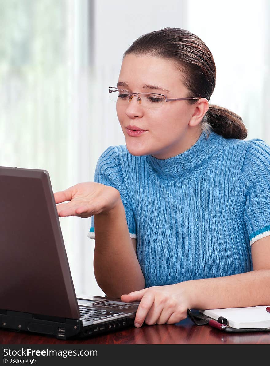 Beautiful businesswoman blowing a kiss in laptop at her office