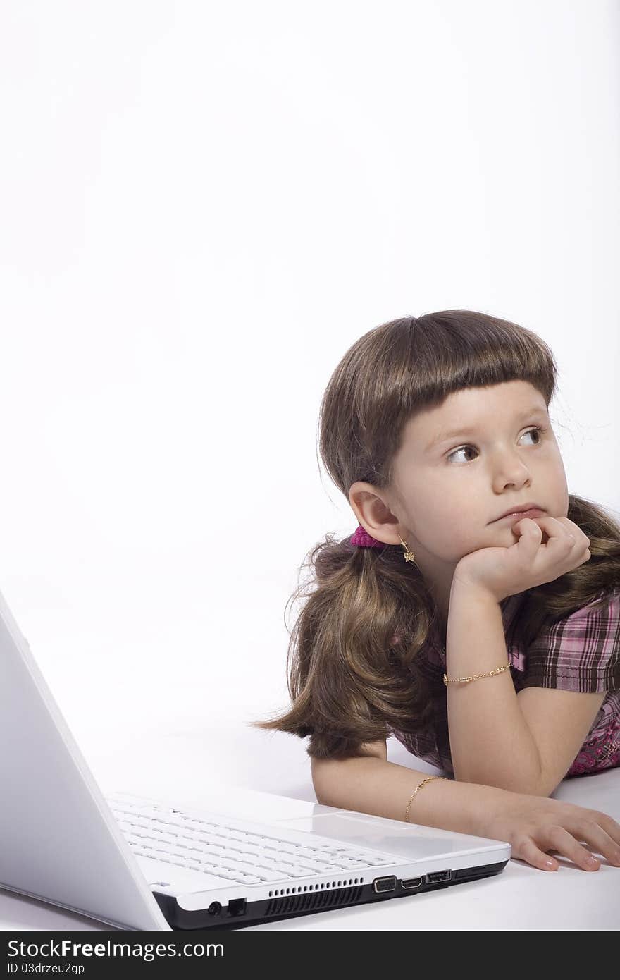 Brunette young girl lying on the floor in front of a computer. Brunette young girl lying on the floor in front of a computer.