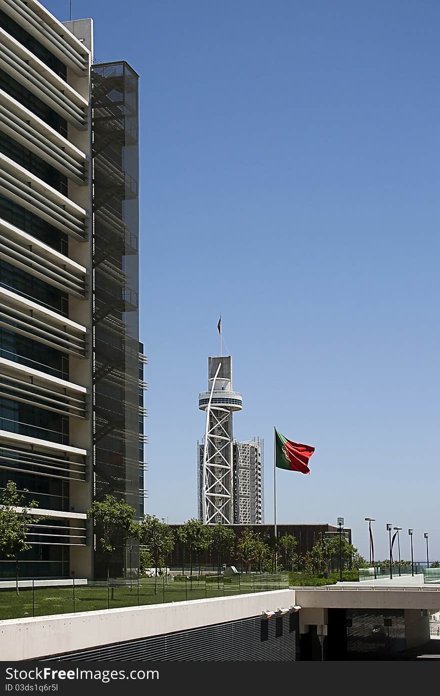 Modern buildings and tower in Lisbon and Portuguese flag. Modern buildings and tower in Lisbon and Portuguese flag