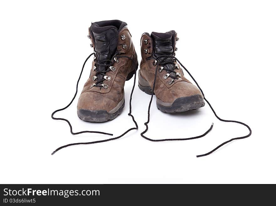 A well-worn pair of leather hiking boots on a white background.