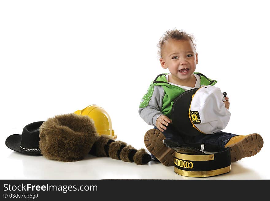 An adorable mixed-race baby trying on a many different style hats. Isolated on white. An adorable mixed-race baby trying on a many different style hats. Isolated on white.