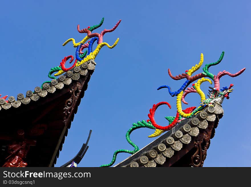 Colorful sculpture by porcelain (mythical beast and sculpt) on the eave. This the traditional temple structure for china southeast. Colorful sculpture by porcelain (mythical beast and sculpt) on the eave. This the traditional temple structure for china southeast.