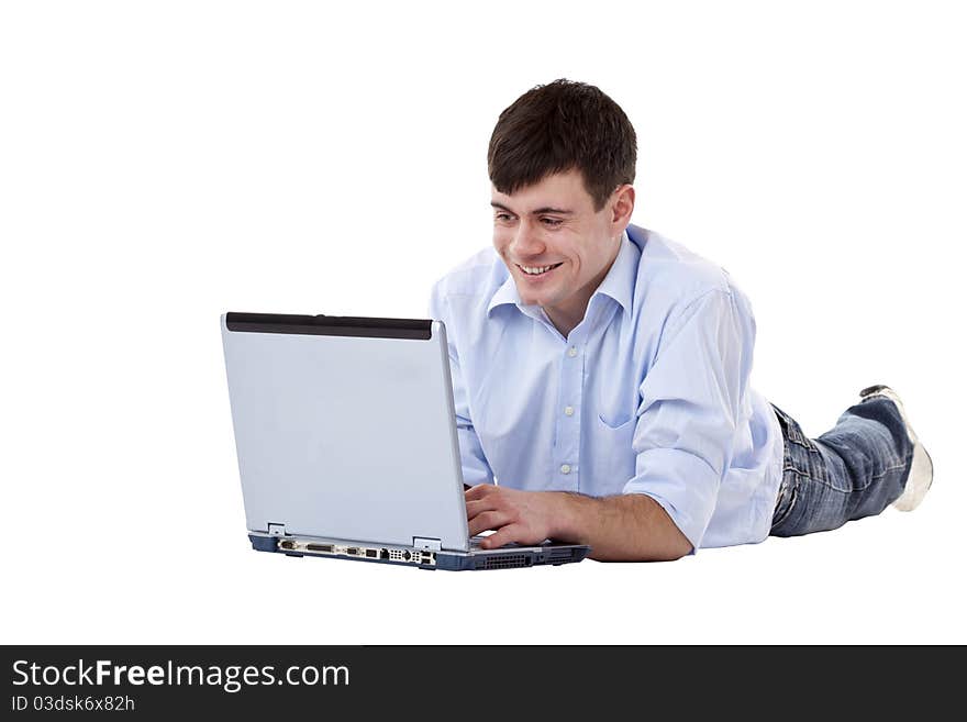 Young handsome man lies on the floor and looks smiling on monitor.Isolated on white background. Young handsome man lies on the floor and looks smiling on monitor.Isolated on white background.