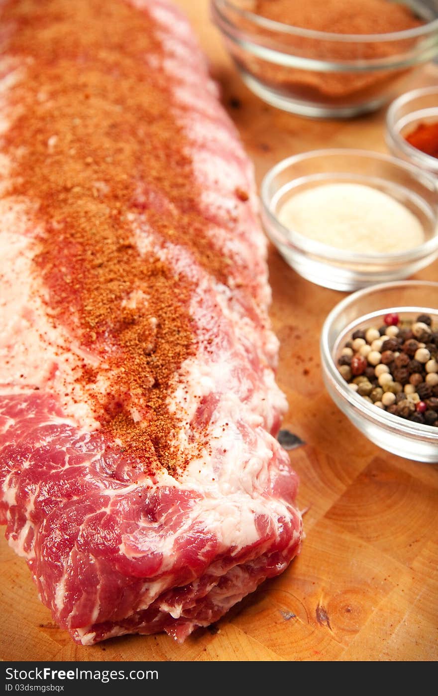 Baby back rib presented with common spices used for rub seasoning. rub seasoning on ribs. Baby back rib presented with common spices used for rub seasoning. rub seasoning on ribs.